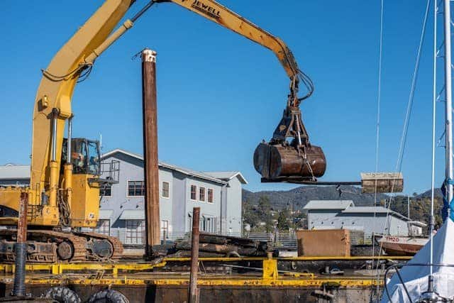 Equipment operator driving heavy machinery at construction site in Saudi Arabia